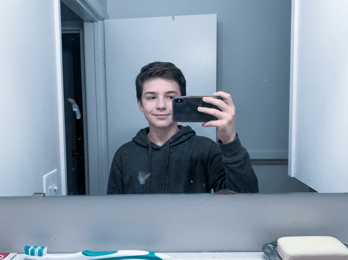 Teenager mirror selfie with age range estimated at 14 to 16 by Lasso face detection